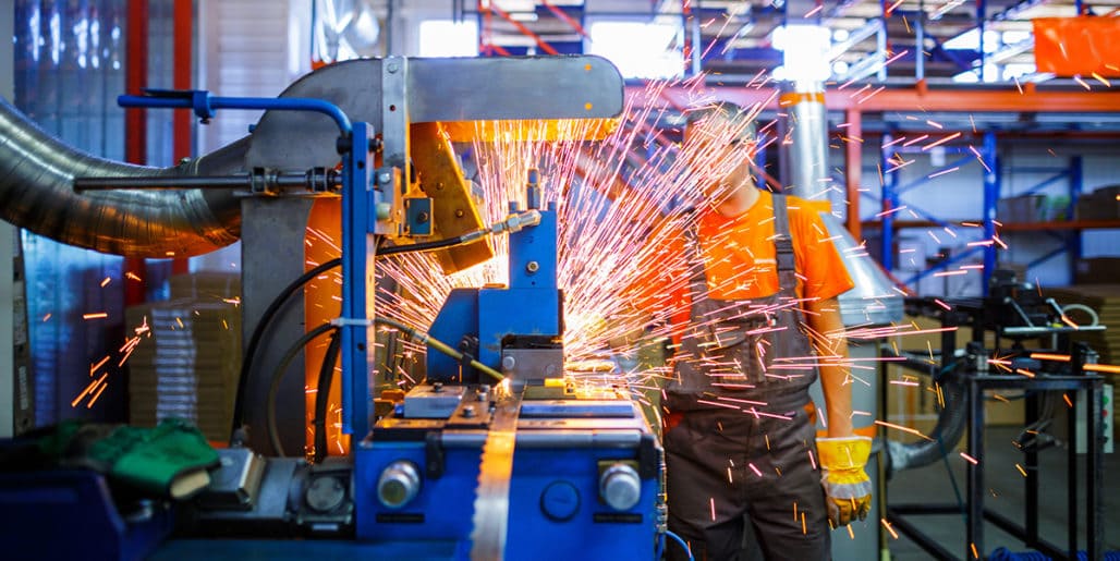 Recovering a health care claims vendor relationship for a heavy equipment manufacturer, featuring an industrial metal cutting machine producing bright sparks.