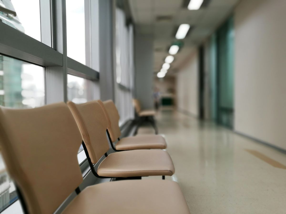 Rows of empty waiting room chairs in a medical facility, representing a U.S.-based healthcare company in a Strategic Benefits Advisors case study on finding a financial education vendor.