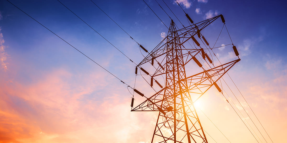 High-voltage electricity pylon representing an energy service provider client in a Strategic Benefits Advisors case study on ACA reporting and compliance.