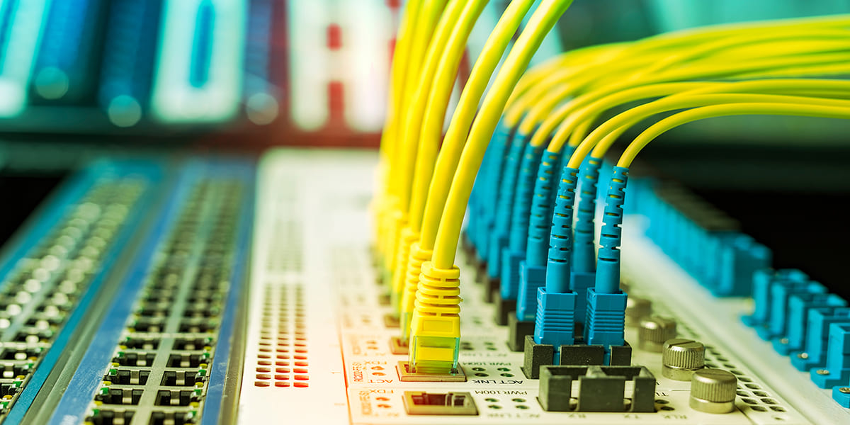 Strategic Benefits Advisors case study: Correcting a multi-year employer match error in a deferred compensation plan for a telecommunications firm, featuring a close-up of network server cables.