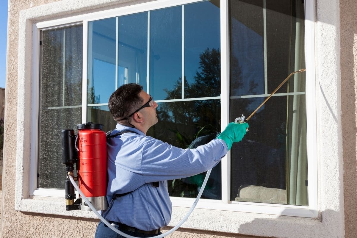 Conducting a 401(k) compliance audit after integrating 1,100 acquired employees for a pest control industry client, featuring a pest control technician treating a home exterior.