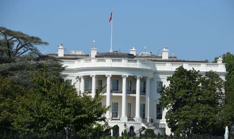 Strategic Benefits Advisors article graphic regarding federal legislative updates for plan sponsors, featuring the South Portico of the White House under a clear blue sky.