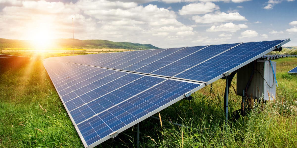 Locating lost pension participants and eliminating RMD violations for a Fortune 500 energy services client, featuring a large solar panel array in a grassy field at sunrise.