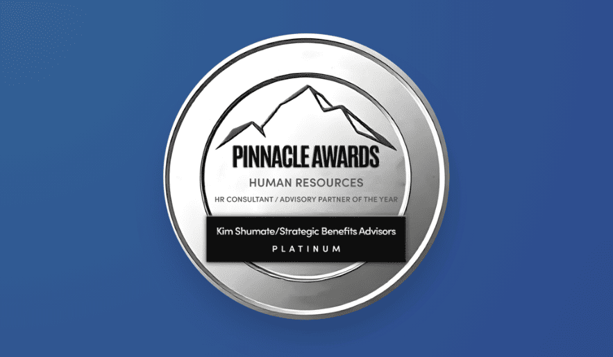 A circular silver Pinnacle Awards badge set against a solid blue background. The top features a mountain peak emblem above text reading "PINNACLE AWARDS," "HUMAN RESOURCES," and "HR CONSULTANT / ADVISORY PARTNER OF THE YEAR". A black banner across the center reads "Kim Shumate/Strategic Benefits Advisors" above "PLATINUM".